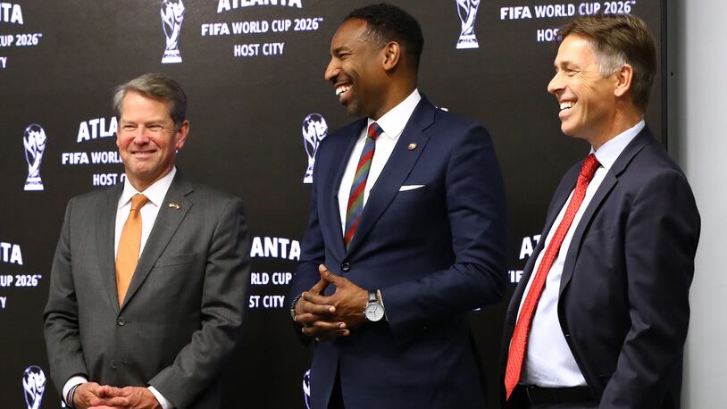 Governor Brian Kemp (from left), Mayor Andre Dickens, and Mercedes-Benz Stadium Chief Operating Officer Dietmar Exler share a laugh reacting during the Host City announcement press conference for the 2026 World Cup at Mercedes-Benz Stadium on Thursday, June 16, 2022, in Atlanta.     “Curtis Compton / Curtis.Compton@ajc.com”