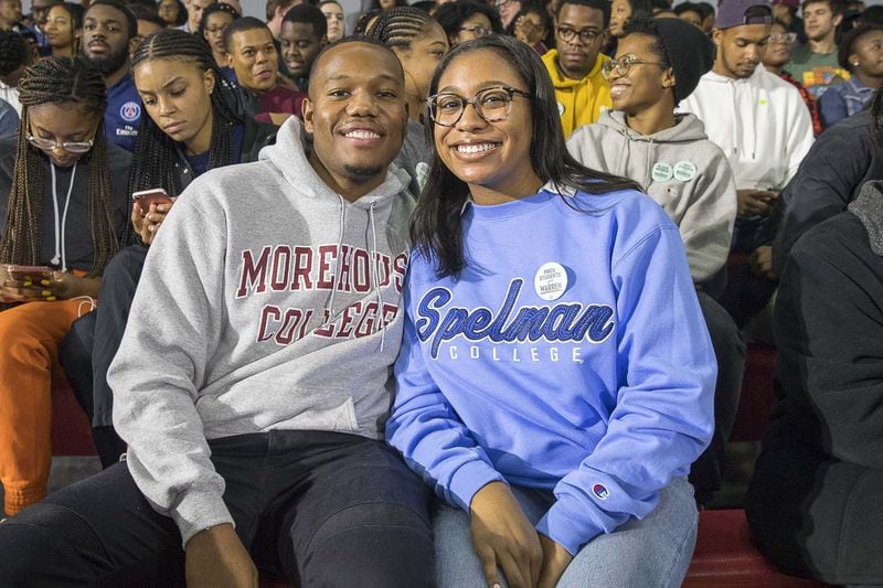 Morehouse College senior Phil Edwards (left) and his girlfriend Spelman College senior Sydney Pascal (right) pose for a photo before the start of an Elizabeth Warren campaign stop at Clark Atlanta University in Atlanta, Thursday, November 21, 2019. 
