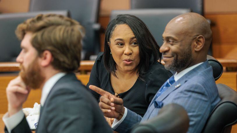 District Attorney Fani Willis (center) reacts to proceedings at Fulton County Superior Court on Thursday, July 21, 2022. State Sen. Burt Jones filed a motion to remove Willis from the Fulton County Trump investigation because she held a fundraiser for Jones’ Democratic opponent Charlie Bailey. (Arvin Temkar / arvin.temkar@ajc.com)