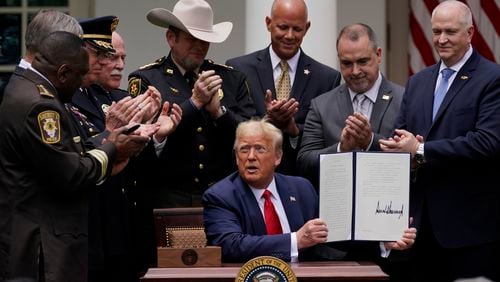 Law enforcement officials applaud after President Donald Trump signed an executive order on policing in the Rose Garden of the White House, Tuesday, June 16, 2020, in Washington. (AP Photo/Evan Vucci)