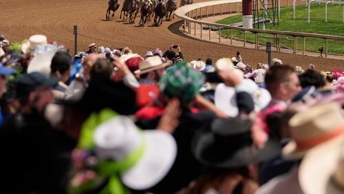 Race fans watch a race at Churchill Downs before the 150th running of the Kentucky Derby horse race Saturday, May 4, 2024, in Louisville, Ky. (AP Photo/Brynn Anderson)