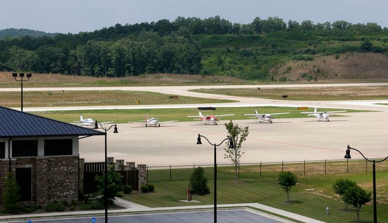 June 25, 2014 - Paulding County - Planes are parked on the tarmac are in an area that is planned for jet operations. New hangers are under construction. The expanded taxiway is visible behind them. The terminal is at left. Taxi way expansion has been completed, and construction continues in FBO area of Paulding County Airport. First, Delta CEO Richard Anderson said he would fight Paulding County's effort to commercialize its airport. Then residents filed four legal challenges. Now, the city of Atlanta is threatening legal action, saying Paulding, which purchased land from Atlanta for the airport back in 2007, is in breach of contract on that deal. Paulding officials deny that and say Atlanta's opposition flies in the face of the regionalism that Mayor Kasim Reed spoke about to leaders there a few years ago. BOB ANDRES / BANDRES@AJC.COM