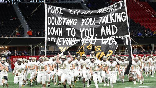 Calhoun players run onto the field before their game against Peach County during the Class AAA Championship at Mercedes-Benz Stadium Friday, December 8, 2017, in Atlanta.