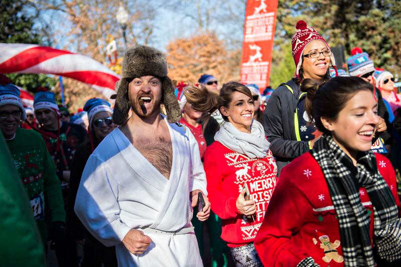 December 19, 2015 Atlanta - Wes Vaughn (left) takes off from the starting line during the Ugly Sweater Run at Piedmont Park in Atlanta on Saturday, December 19, 2015. Thousands of people donned their ugliest holiday themed gear to make their way through the course. JONATHAN PHILLIPS / SPECIAL
