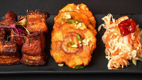 West Midtown’s Rock Steady has a menu based on dishes of the Afro-Caribbean diaspora, including these dishes from Haiti, (from left) griot (braised pork shoulder), tostones (fried plantains) and pikliz (a vinegar-based slaw). STYLING BY CHRISTIAN LUCKE BELL / CONTRIBUTED BY CHRIS HUNT PHOTOGRAPHY