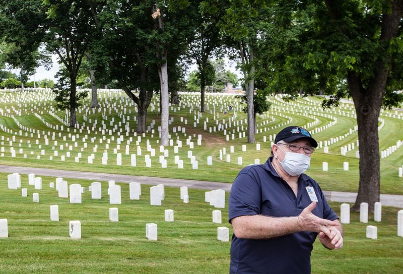 Historian Brad Quinlin, who normally is giving group tours of the Marietta National Cemetery during Memorial Day weekend, is out placing a few flags and visiting the grounds Saturday, May 23, 2020. Quinlin said freed slaves placed flower petals on headstones in the cemetery in 1868 to honor the Union soldiers who fought for their freedom, and flags have been placed at each gravesite on the grounds since 1869, a Memorial Day or Decoration Day tradition that was put on hiatus this year. (Jenni Girtman for Atlanta Journal-Constitution)
