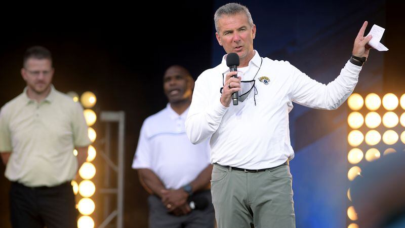 Jacksonville Jaguars coach Urban Meyer addresses the crowd, backed by offensive coordinator Darrell Bevell (left) and assistant head coach Charlie Strong, during an NFL draft party Thursday, April 29, 2021, in Jacksonville, Fla. (Bob Self/The Florida Times-Union)