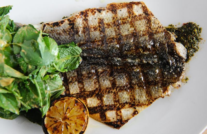 Wood Grilled Branzino with charmoula, seven herb salad, charred lemon at Drift. (BECKY STEIN PHOTOGRAPHY)