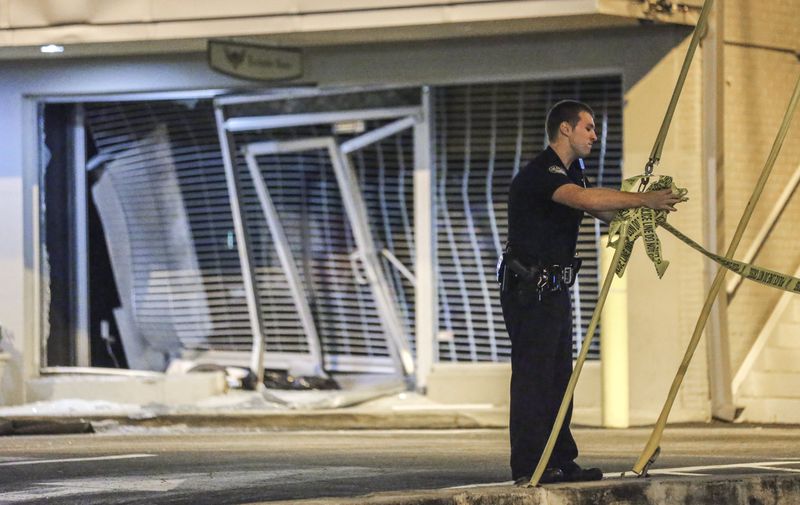 LEDE PHOTO 1 - October 5, 2015 Atlanta: Atlanta police had a busy Monday morning investigating two smash-and-grabs. At 3:45 a.m. burglars drove a vehicle through the front doors of a high-end Buckhead clothing boutique, leaving a mess of shattered glass and bent security screens (shown here). Atlanta police have not said how much merchandise was stolen by at least two suspects during the 3:45 a.m. smash-and-grab burglary at the Exclusive Game Mens Style House at Peachtree and Piedmont roads. The thieves sped away in a black Dodge Charger, police said. At a midtown print shop, dramatic surveillance video shows thieves carrying out a brazen smash-and-grab burglary at a Midtown print shop on Monday, Oct. 5, 2015 - the third break-in since July at Creative Approach on West Peachtree Street. The video, obtained by The Atlanta Journal-Constitution, clearly shows five people, four wearing hoodies and one with a T-shirt tied around his face to conceal his identity. They heave a large rock at the shops plate glass window not once or twice, but four times before shattering the window enough to gain entry. The video then shows one suspect running away with a computer. The others struggle for several seconds to pull computer monitors out the shattered window before dropping the large monitors on the sidewalk and running away empty-handed. The entire break-in lasted less than a minute. Witnesses told police the suspects who appear to be from 15- to 19-years-old, got in a dark-colored sedan with a loud muffler and sped away from the scene. Its getting really, really old, Creative Approach general manager Jeff Cela said. Something has to be done. In July, thieves broke into the print, design and marketing company and took 20 iMac computers, The Atlanta Journal-Constitution previously reported. The shop was broken into a second time on Sept. 4, according to police, but it was not clear Monday what, if anything, the thieves took in that incident. JOHN SPINK /J