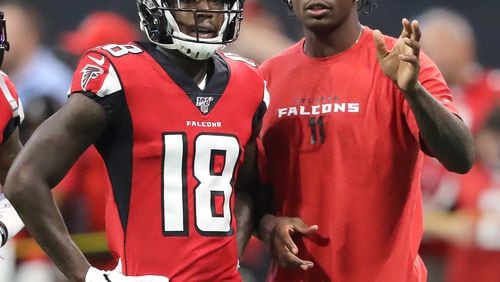 Falcons wide receiver Julio Jones, who is not playing in the game, gives wide receiver Calvin Ridley some pointers before he runs a route as the team prepares to play the New York Jets in a NFL preseason football game on Thursday, August 15, 2019, in Atlanta.   Curtis Compton/ccompton@ajc.com