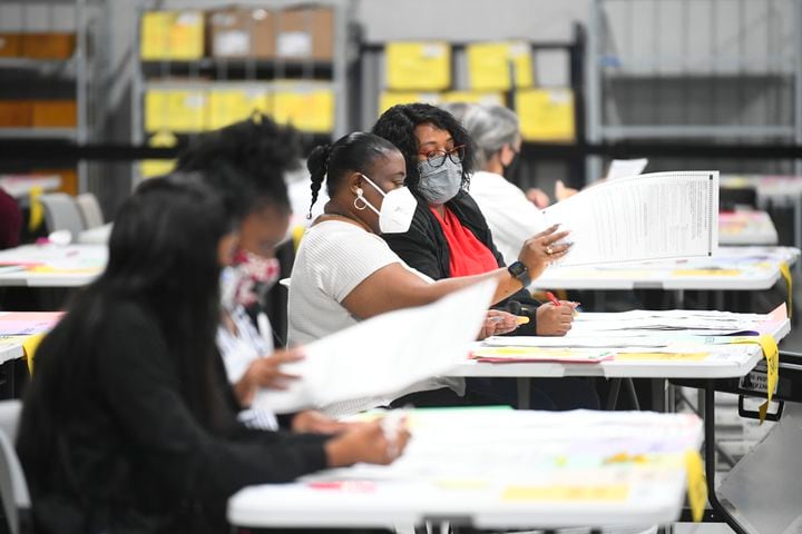 Elections workers stay busy as votes for President are recounted at the Gwinnett County elections office on Friday, Nov.13, 2020 in Lawrenceville. (JOHN AMIS FOR THE ATLANTA JOURNAL-CONSTITUTION)