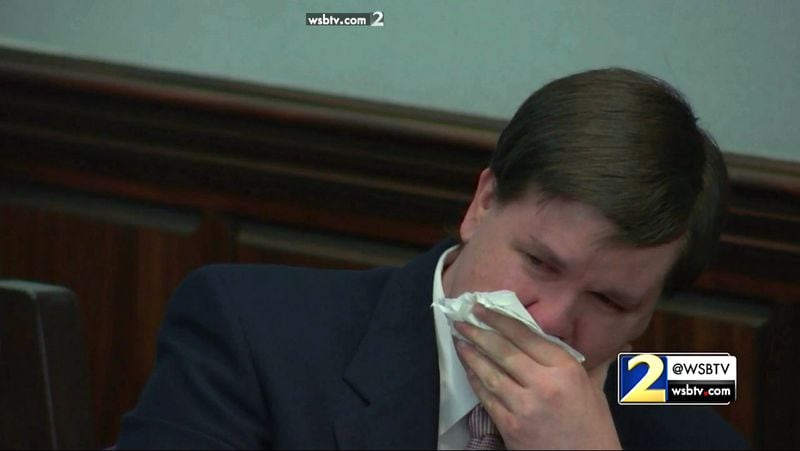 Justin Ross Harris cries while watching the final image of the defense's closing statement -- a video of Harris playing guitar with Cooper -- during Harris' murder trial at the Glynn County Courthouse in Brunswick, Ga., on Monday, Nov. 7, 2016. (screen capture via WSB-TV)