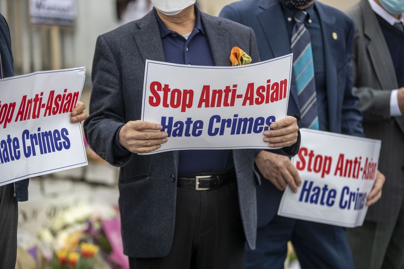 Members of the Atlanta Korean American Committee Against Asian Hate Crimes hold signs during a a vigil for the victims of the spa shootings outside of the Gold Spa in Atlanta on March 19, 2021. The committee consists of Korean-American community members, business leaders and religious leaders.  (Alyssa Pointer / Alyssa.Pointer@ajc.com)