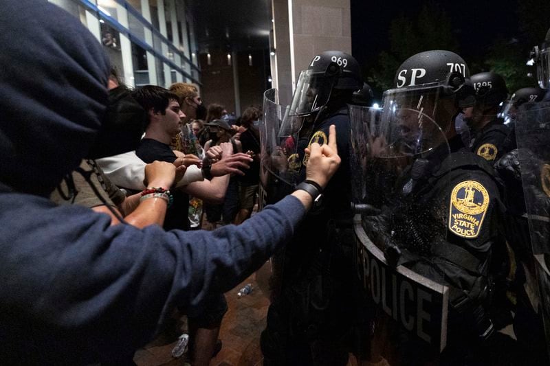 EDS NOTE: OBSCENITY - Demonstrators and law enforcement officers clash during a pro-Palestinian rally at Virginia Commonwealth University, Monday, April 29, 2024, in Richmond, Va. (Mike Kropf/Richmond Times-Dispatch via AP)