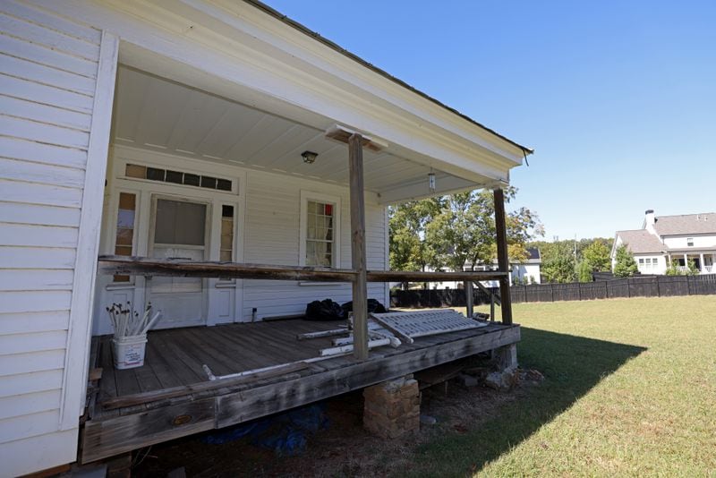 The front porch of the Hembree farmhouse is shown. The historic home in Roswell was built in 1835 and belong to one of the city’s original family settlers.  (Jason Getz / Jason.Getz@ajc.com)