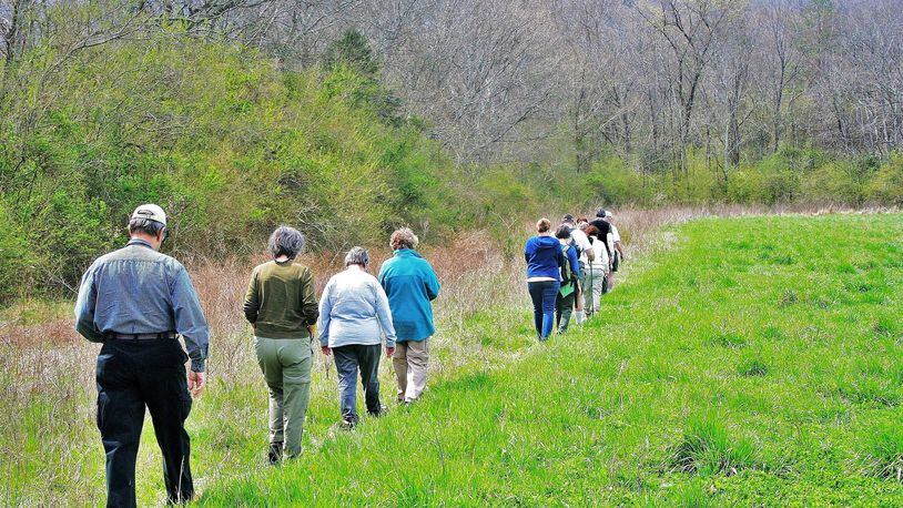 Georgia Botanical Society members and others stroll across a field in Walker County during an early spring botany walk. The society is one of several groups and state agencies that offer outings across Georgia throughout the year to observe and learn about nature. PHOTO CREDIT: Charles Seabrook