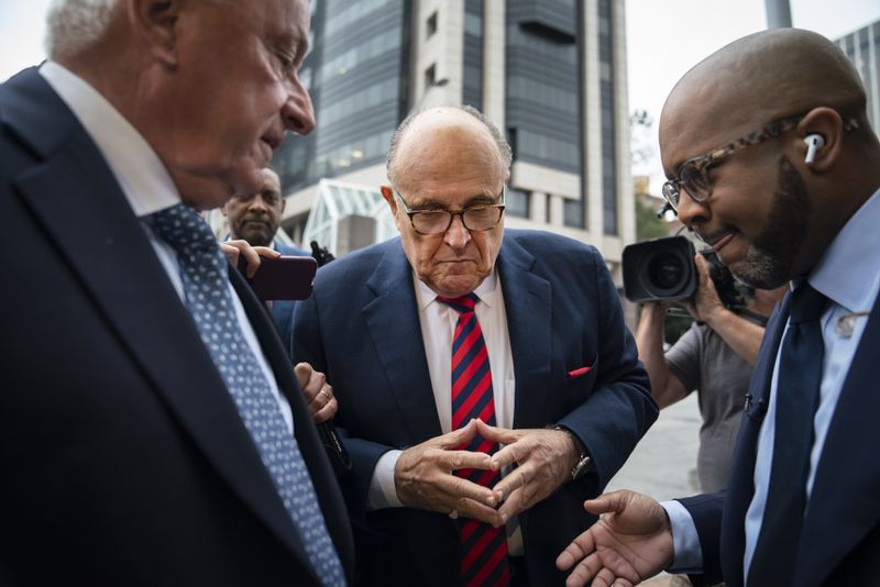 Rudy Giuliani, center, Donald Trump’s former personal lawyer, arrives at the Fulton County Courthouse for a grand jury appearance in Atlanta, Aug. 17, 2022. Giuliani urged Trump to follow through with a plan to simply declare victory in the 2020 election. (Nicole Craine/The New York Times)