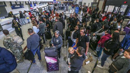 Passengers still felt the effects of last month's power outage the day after, with ticket counters swamped with travelers. JOHN SPINK/JSPINK@AJC.COM