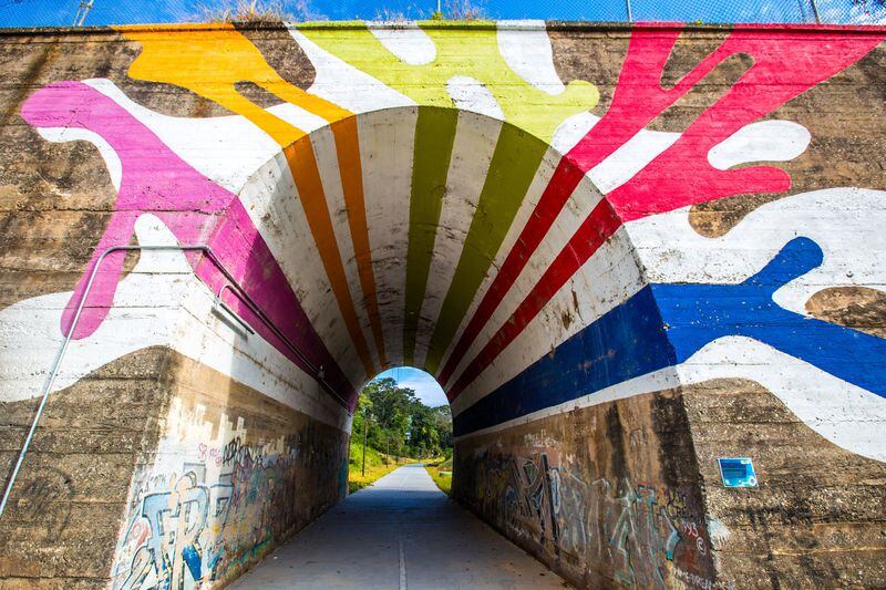 “The Highball Artist” is a mural created by Hadley Breckenridge on the tunnel that runs under Lucille Street on the Westside Trail of the Beltline. The path is now paved, has lighting and security cameras and is officially open to the public. The art piece’s title is a reference to railroad slang for an engineer known for running trains fast. CONTRIBUTED BY JENNI GIRTMAN / ATLANTA EVENT PHOTOGRAPHY