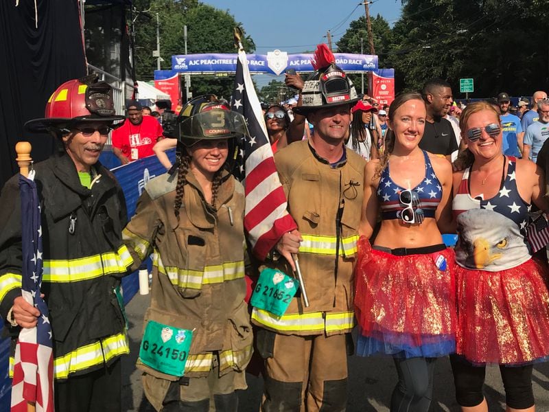 Participating firefighters take a photo after finishing the AJC Peachtree Road Race