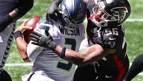 Falcons defensive end Dante Fowler helps sack Seattle Seahawks quarterback Russell Wilson.   “Curtis Compton / Curtis.Compton@ajc.com”
