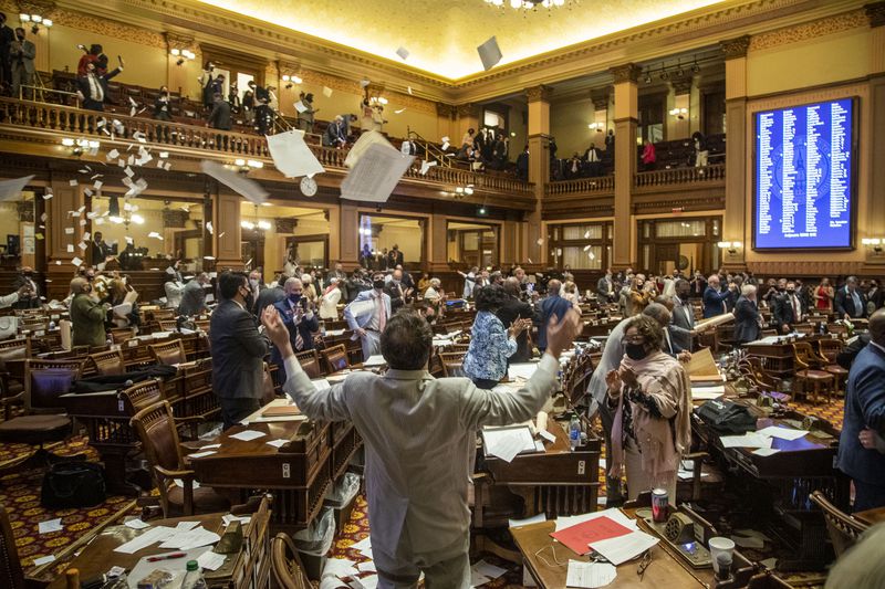 03/31/2021 —Atlanta, Georgia — House Representatives throw paper in the air in the House Chambers following Sine Die, legislative day 40, at the Georgia State Capitol in Atlanta, Wednesday, March 31, 2021. (Alyssa Pointer / Alyssa.Pointer@ajc.com)