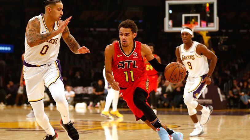 Trae Young of the Hawks moves the ball down the court as Kyle Kuzma (0) of the Los Angeles Lakers defends November 17, 2019 in Los Angeles. (Photo by Katharine Lotze/Getty Images)