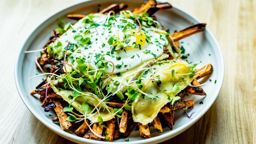The disco frites at Tin Tin include duck "gravy," brie and a fried duck egg.