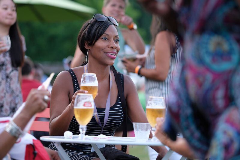 Charita Gray enjoys a beer with her friends during the Atlanta Food and Wine Festival's Friday Night Bites event at Piedmont Park on Friday evening June 3, 2016. Ben Gray / bgray@ajc.com