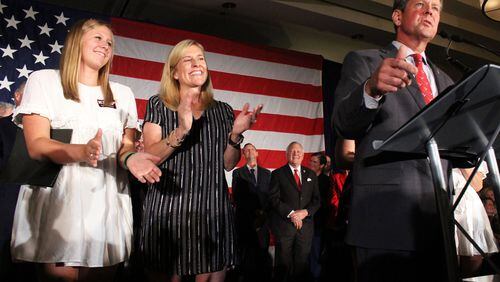 Jarrett and Marty Kemp clap Brian Kemp, right, speaks at a Republican "unity rally." Jenna Eason / Jenna.Eason@coxinc.com