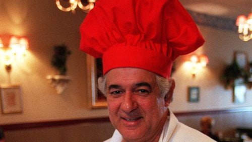 990128 NORTH FULTON, GA --Antonio Fundora (cq), owner and head cook at Casa Nuova on Hwy 9 North in Alpharetta, prepares freshly cooked fine Italian cuisine. He holds two of their popular specialties, Zuppe Di Pesci & Linguini with fresh grouper, clams, mussels, calamari and scungilli sauteed in white wine, plum tomato sauce, garlic and italian herbs at $19.95; and to the left a dish of Veal Francese, medallions of veal buttered and sauteed in white wine and fresh lemon butter sauce at $12.50. (ALICIA HANSEN/STAFF)