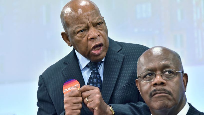 U.S. Rep. John Lewis speaks as Fulton County District Attorney Paul Howard (foreground) sits next him during a town hall discussion about the impact of gun violence at the Martin Luther King Sr. Community Resources Complex in Atlanta on Wednesday, June 29, 2016. HYOSUB SHIN / HSHIN@AJC.COM