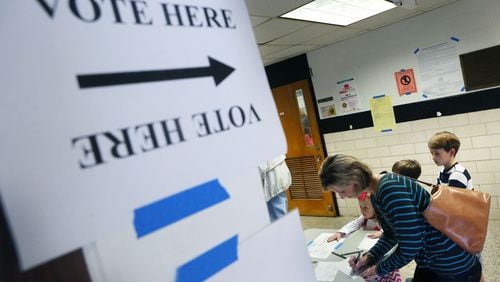 Nov. 3, 2015 - DeKalb County - Helen Garner signs in at Hawthorne Elementary, where city hood for LaVista Hills was on the ballot, with 275 voters by 11am. She said she voted yes for city hood and for ethics reform. DeKalb County residents could vote on an ethics overhaul for the county and city hood for LaVista Hills and Tucker. Hawthorne Elementary is one of the busiest precincts in DeKalb, where voters will consider overhauling the county's ethics rules and city hood for LaVista Hills. BOB ANDRES / BANDRES@AJC.COM