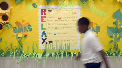 A student walks past a Georgia Milestones Assessment bulletin board at Thurgood Marshall Elementary on Wednesday, April 19, 2022.  Teachers and faculty created the bulletin boards about a month before Milestones testing as a way to motivate and encourage students. (Natrice Miller / natrice.miller@ajc.com)