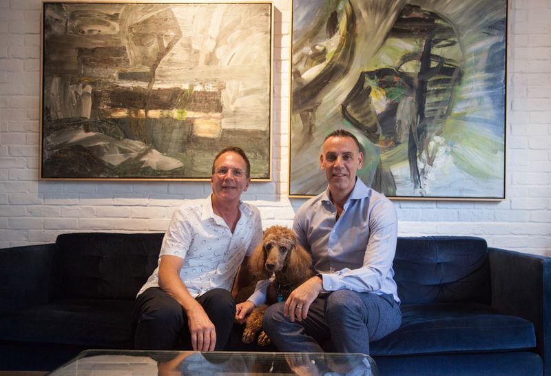 Mark (left) and Dave Curran, with their dog, Chelsea, purchased the 1,610-square-foot brick townhome in Castleberry Hill in 2003. Mark manages commercial real estate and Dave sells software to colleges.
