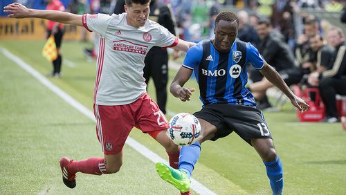 Montreal Impact’s Ballou Jean-Yves Tabla, right, challenges Atlanta United’s Mark Bloom during second-half MLS soccer game action in Montreal, Saturday, April 15, 2017. (Graham Hughes/The Canadian Press via AP)