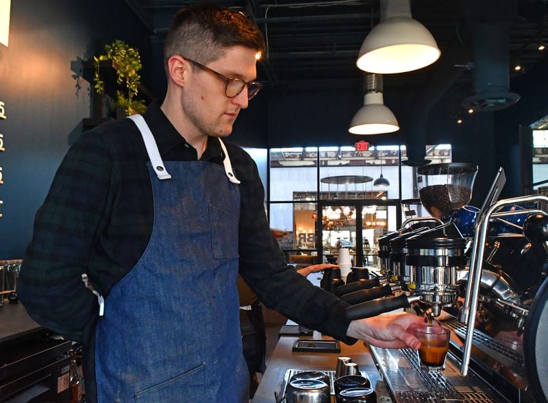 Richie Hicks, director of retail at Brash Coffee Roasters, pulls an espresso for a customer Friday, Jan. 27, 2023, at the location at The Works on Chattahoochee Avenue in Atlanta. Hicks thinks about coffee as an ingredient as well as a beverage. (Chris Hunt for the AJC)