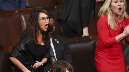 Republican U.S. Reps. Lauren Boebert of Colorado and Marjorie Taylor Greene of Rome, shown screaming "Build the Wall" at President Joe Biden during his State of the Union address in 2022, used to be allies. But the two had a testy exchange on the House floor Wednesday over rival proposals seeking Biden's impeachment. (Evelyn Hockstein/Pool/Getty Images/TNS)