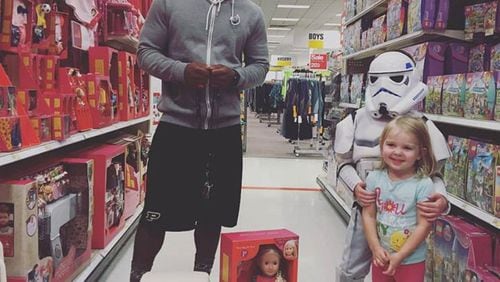 Tario Fuller, a football player at Purdue University and Gwinnett native, with a doll he bought for two-year-old Kinley for her birthday at a Target in Indiana. Photo by Megan Shufflebarger.