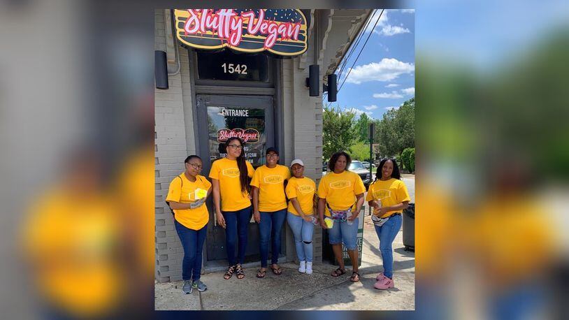 Wait Up! team members pose during their launch day in front of Slutty Vegan in Atlanta on Saturday, June 1, 2019.