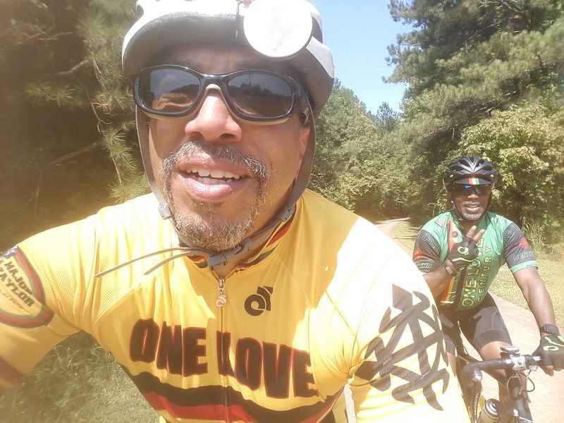 Russell “Junior Deas” DeBarros, left, with fellow cyclist Mitchell Smith on a recent ride.