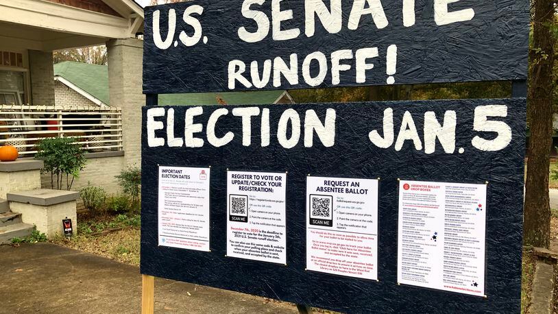 A sign in the front yard of a home in Atlanta's Westview neighborhood reminds residents about the upcoming U.S. Senate runoff elections in Georgia.