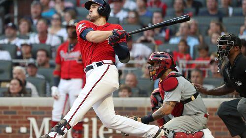 Braves left fielder Adam Duvall swings for the fence in the seventh-inning, his two-run home run breaking open Game Two of the National League Division Series against St. Louis.  (JASON GETZ/SPECIAL TO THE AJC)
