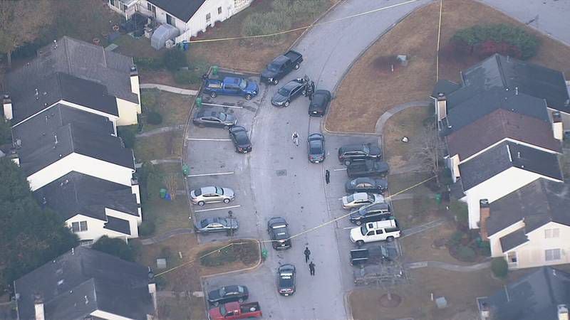 There was a large police presence Wednesday morning outside a home on Wellington Circle in the Lithonia area, where a shooting injured two officers.