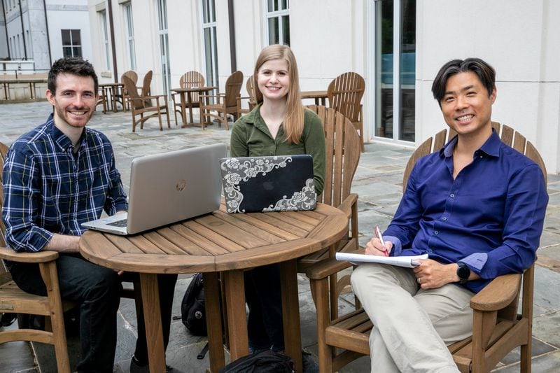 Outside of Emory University's Mathematics and Science Center, graduate students James Finch and Sarah Finch, a married couple, from left, and professor Jinho Choi are together Thursday, Sept. 16, 2021. The group participated and won Amazon competitions but have taken their chat bot project further than the Amazon parameters and they continue to push technology boundaries while studying at Emory University. (Jenni Girtman for The Atlanta Journal-Constition)