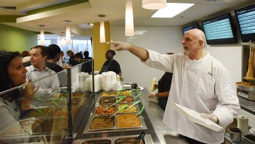 Owner Kameel Srouji recognizes a regular customer and calls “I love you” as he serves lunch at Aviva by Kameel, a Mediterranean restaurant inside the Mall at Peachtree Center food court in downtown Atlanta, on Sept. 30. HYOSUB SHIN / HSHIN@AJC.COM