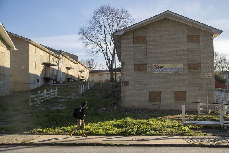 A school-aged boy walks along Delmar Lane NW, near the boarded up and permanently closed Sierra Ridge Apartments in Atlanta’s west side, Wednesday, January 22, 2020. The apartments, a 28-building property, were ordered to be demolished on April 30, 2018 after a Atlanta Municipal Court judge ruled that the property owners failed to prove the property fit for human habitation. “We hope other irresponsible property owners will take notice and work to provide clean, respectable housing for its residents,” Atlanta Police Chief Erika Shields said in a statement. The apartment complex is located within the Harper-Archer school district. (ALYSSA POINTER/ALYSSA.POINTER@AJC.COM)