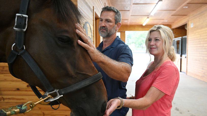 Kyle and Cindy Hester share their moment with Leo at Hester’s horse farm home (Hyosub Shin / Hyosub.Shin@ajc.com)