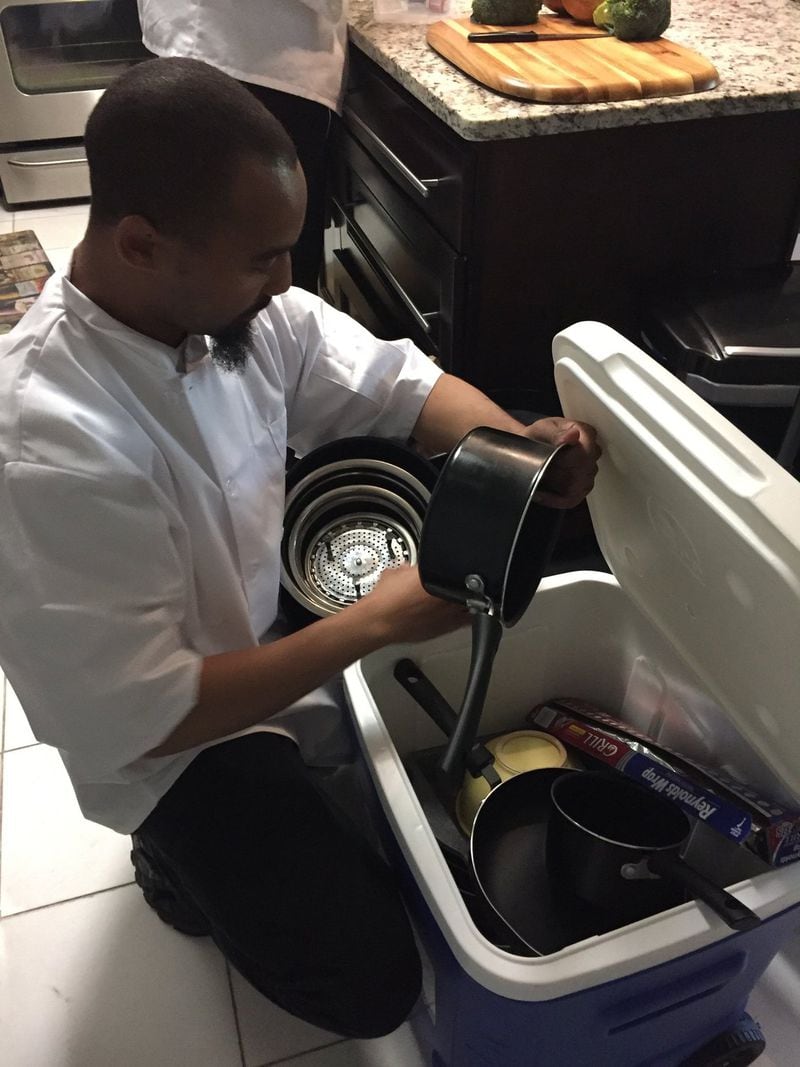 When Chefs for Seniors arrives at a client’s home, they bring everything that’s needed, from the groceries to pots and pans and knives and seasonings. Here, Christopher Watts unpacks the pans he ll need to prepare salmon with mustard-dill sauce. Photo: C.W. Cameron