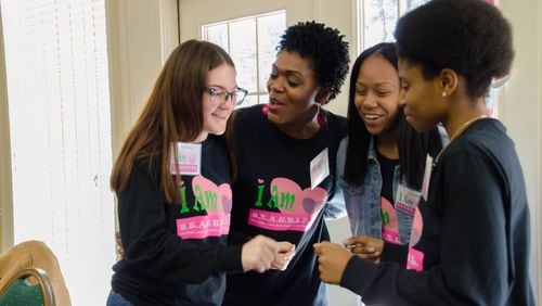 Tina Woodard sings as she teaches the lyrics of the I Am B.E.A.U.T.I.F.U.L. song to girls attending the annual Pink Pajama Jam recently at Lake Lanier. CONTRIBUTED